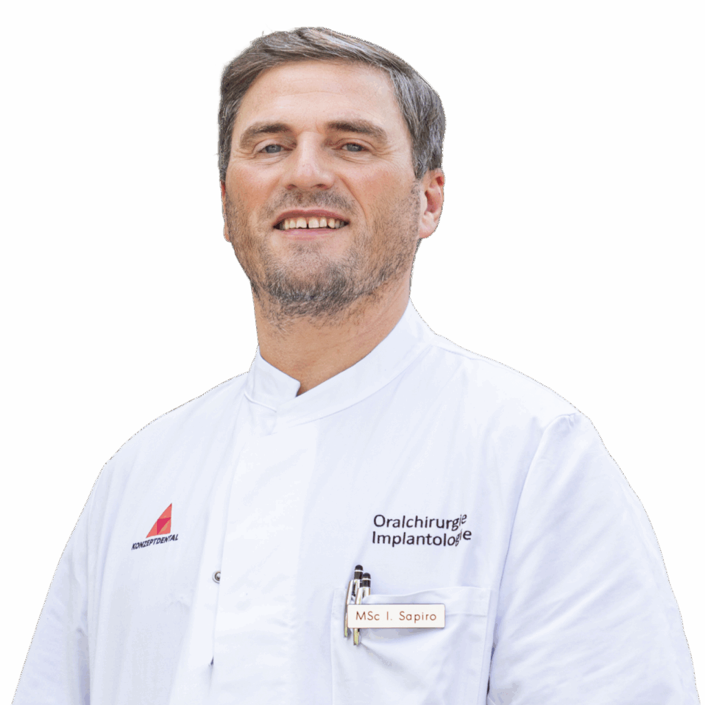 Zahnarzt in weißem Kittel, spezialisiert auf Oralchirurgie und Implantologie.